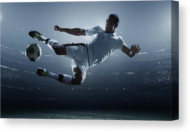 Goal Canvas Print featuring the photograph Soccer Player Kicking Ball In Stadium by Dmytro Aksonov Goal Canvas Print featuring the photograph Soccer Player Kicking Ball In Stadium by Dmytro Aksonov