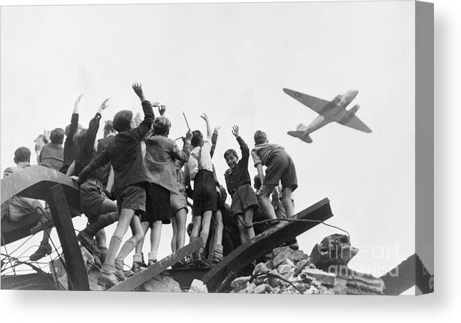 Rubble Canvas Print featuring the photograph Berlin Children Cheering Airlift Plane by Bettmann