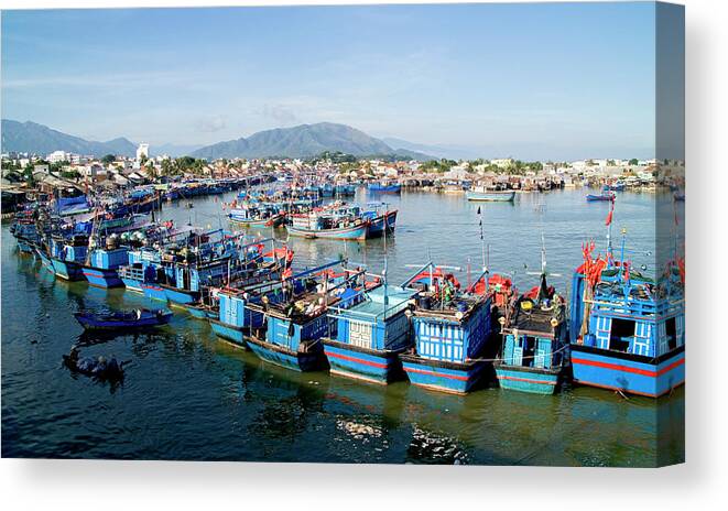 In A Row Canvas Print featuring the photograph Vietnam, Nha Trang, Fishing Boats In by David Buffington