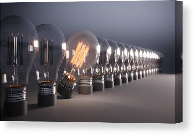 Corporate Business Canvas Print featuring the photograph Glowing Light Bulb Standing Out From the Crowd #1 by Eoneren