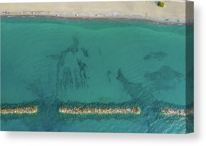 Beachfront Canvas Print featuring the photograph Aerial view from flying drone of people relaxing on the beach. Paphos Cyprus by Michalakis Ppalis
