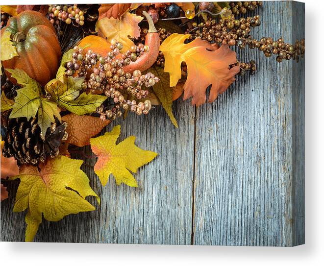 Nature Canvas Print featuring the photograph Autumn leaves and berry over wooden background for Thanksgiving #2 by Brandon Bourdages
