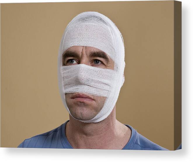 Material Canvas Print featuring the photograph Portrait of a man with a bandaged face by Uwe Umstatter