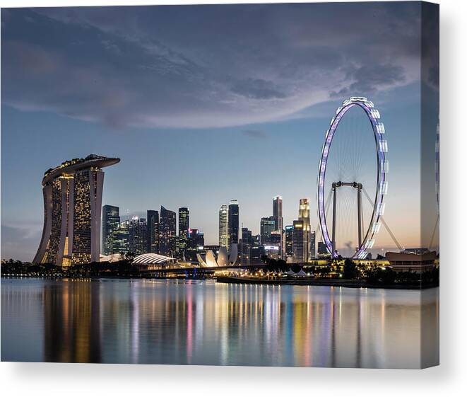 Built Structure Canvas Print featuring the photograph Singapore Skyline At Dusk by Martin Puddy