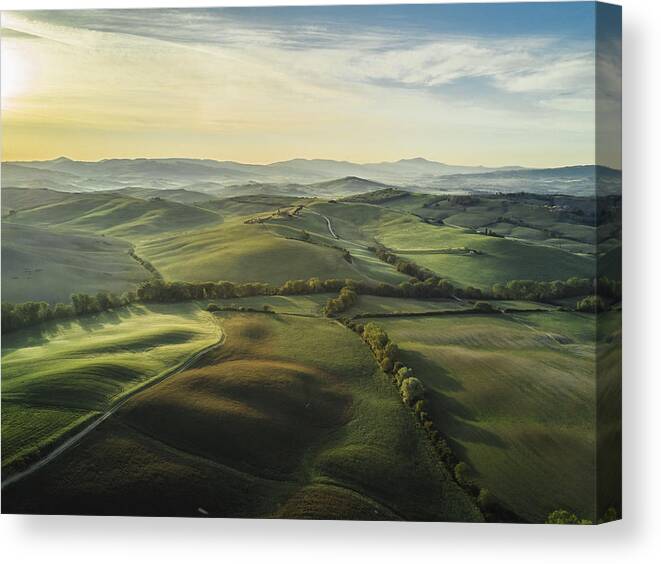 Tranquility Canvas Print featuring the photograph Tuscany landscape at sunrise with low fog by FilippoBacci