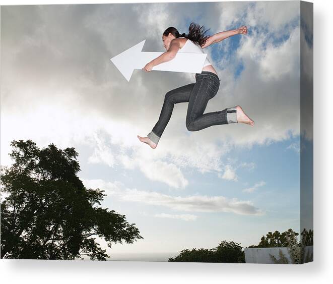 Viewpoint Canvas Print featuring the photograph Woman with blank arrow leaping outdoors by Robert Daly