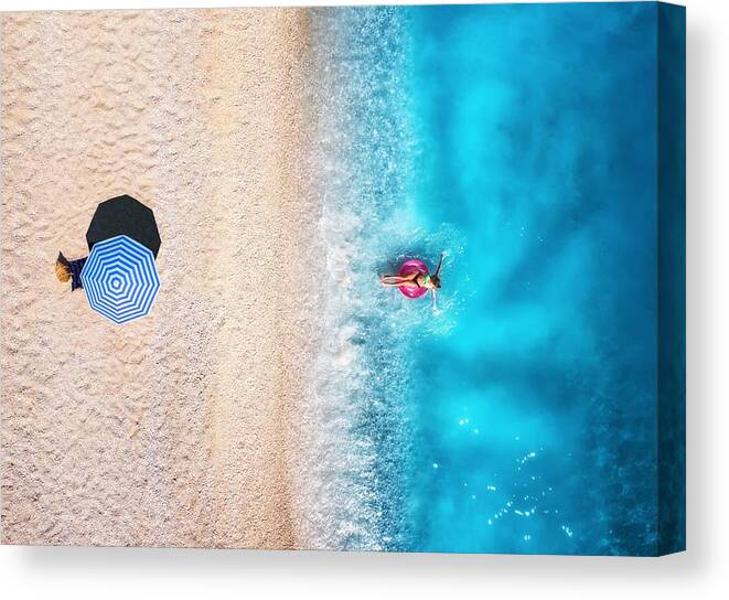 Oceans Canvas Print featuring the photograph Aerial View Of A Woman Swimming by Denys Bilytskyi