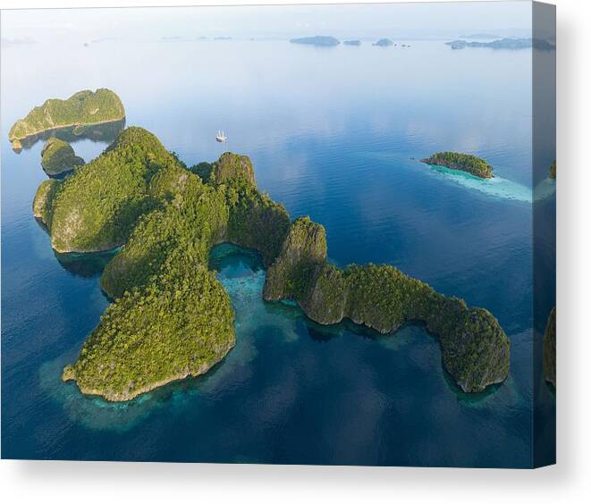 Landscapeaerial Canvas Print featuring the photograph Coral Reefs Surround The Dramatic by Ethan Daniels