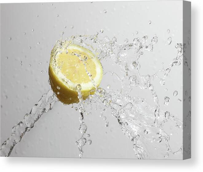 Motion Canvas Print featuring the photograph Cut Lemon Splashed With Water by Vincenzo Lombardo