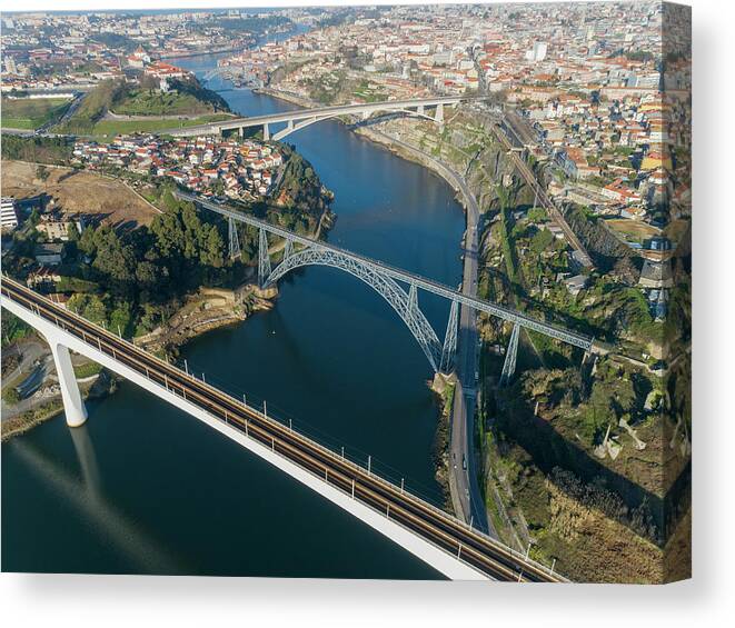 Portugal Canvas Print featuring the photograph Aerial of bridges and Douro river in Porto #1 by Mikhail Kokhanchikov