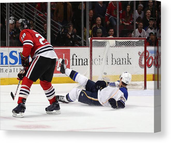 United Center Canvas Print featuring the photograph St. Louis Blues v Chicago Blackhawks #26 by Jonathan Daniel
