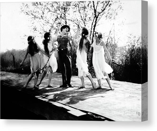 Dancing Canvas Print featuring the photograph Charlie Chaplin Frolicking with Dancing Nymphs by Sad Hill - Bizarre Los Angeles Archive