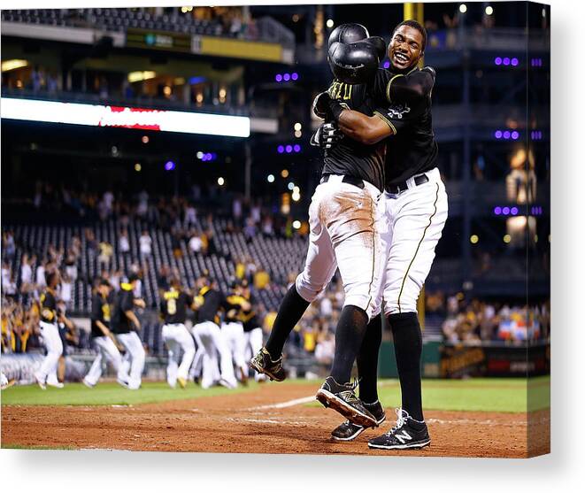 People Canvas Print featuring the photograph Francisco Cervelli and Gregory Polanco by Jared Wickerham