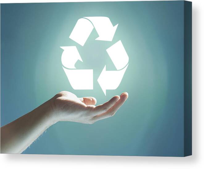People Canvas Print featuring the photograph Glowing recycling sign floating above hand by Paper Boat Creative