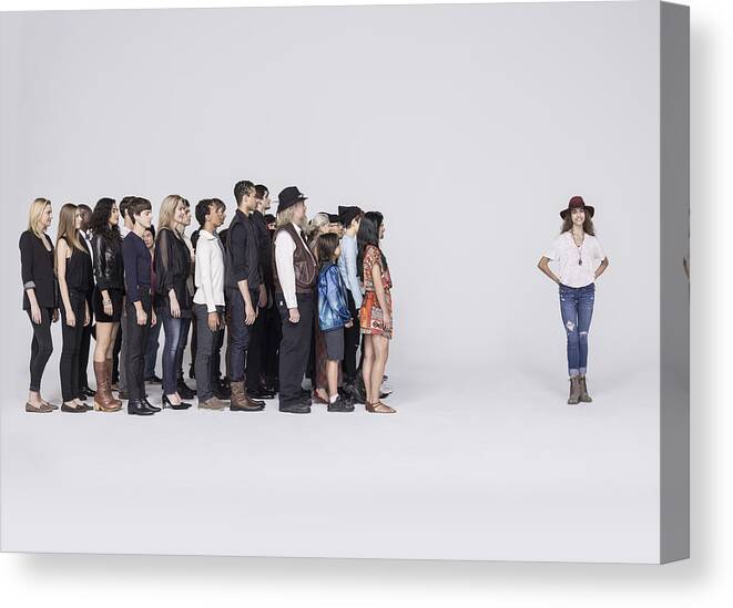 Young Men Canvas Print featuring the photograph Large Group of people looking at woman by Nisian Hughes
