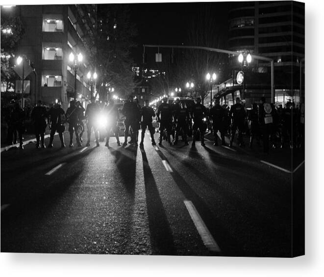 Shadow Canvas Print featuring the photograph Line of police officers in riot gear by Ivan McClellan