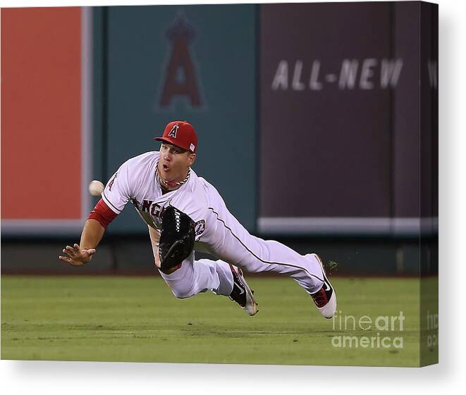 Yoenis Cespedes Canvas Print featuring the photograph Yoenis Cespedes and Mike Trout by Jeff Gross