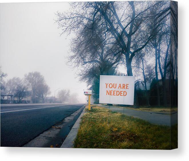 Outdoors Canvas Print featuring the photograph You are needed sign in a small town on a foggy morning. by Harpazo_hope