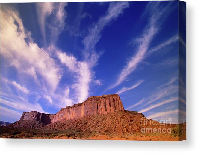 00340878 Canvas Print featuring the photograph Clouds Over Monument Valley by Yva Momatiuk and John Eastcott