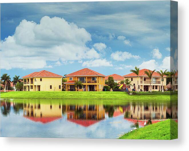 Water's Edge Canvas Print featuring the photograph Houses By The Lake #1 by Thepalmer