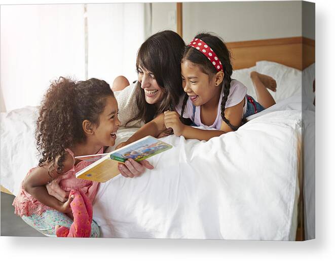 4-5 Years Canvas Print featuring the photograph Mother & 2 kids lauging & reading in bedroom by Klaus Vedfelt