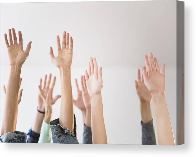 Young Men Canvas Print featuring the photograph People's hands raised in air by JGI/Jamie Grill