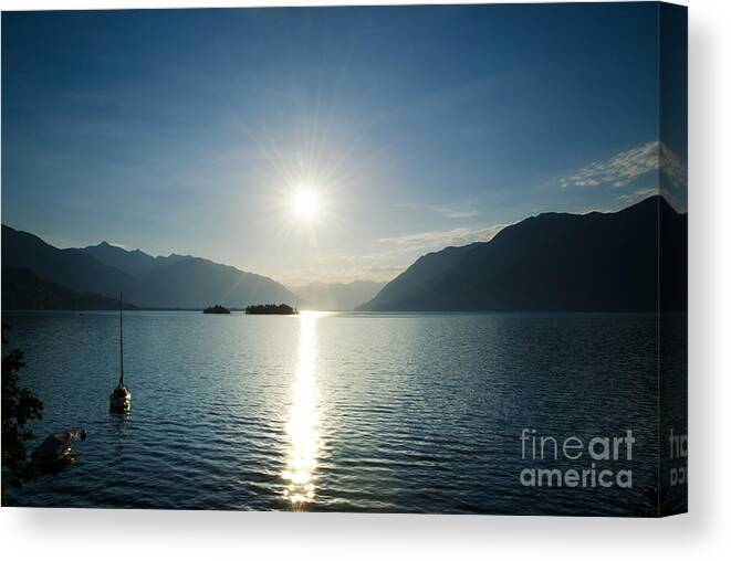 Sunrise Canvas Print featuring the photograph Sunrise reflected over an alpine lake by Mats Silvan