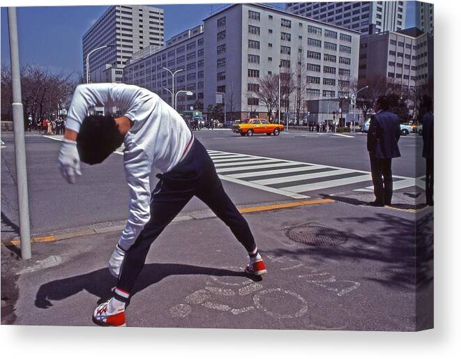 Japan Canvas Print featuring the photograph Young Japanese man practices yoga on the sidewalk Tokyo by Blair Seitz