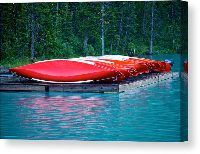 Alberta Canvas Print featuring the photograph Canoes on Lake Louise by Mike Horvath