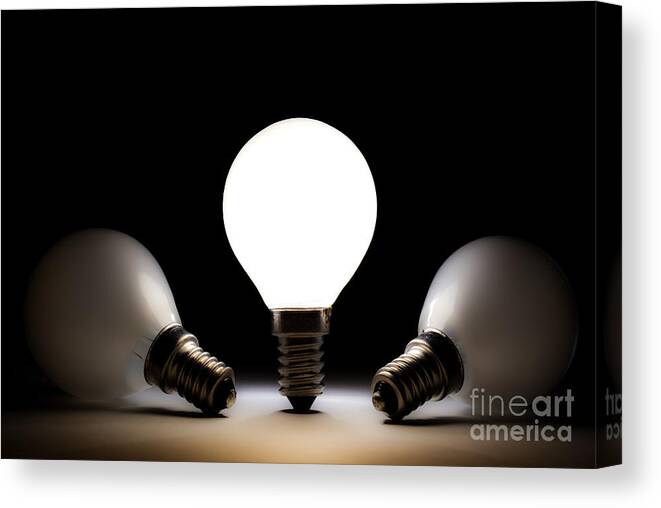 Light Bulb Canvas Print featuring the photograph One light bulb shining by Simon Bratt