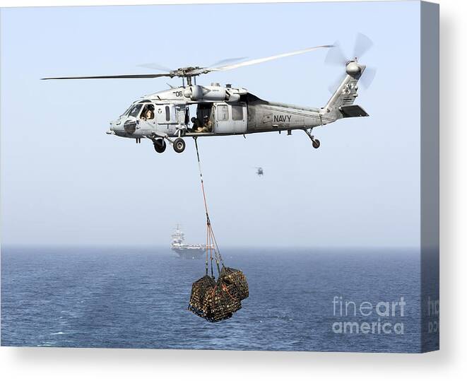 Arabian Sea Canvas Print featuring the photograph A Mh-60 Helicopter Transfers Cargo by Gert Kromhout