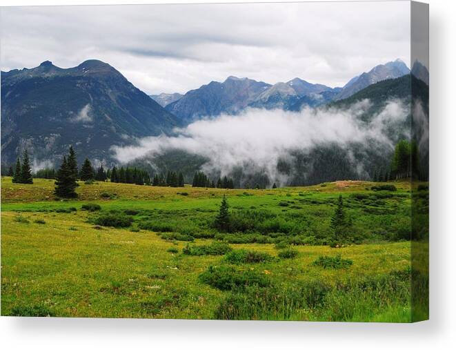 Mountains Canvas Print featuring the photograph Above The Clouds by Brad Hodges