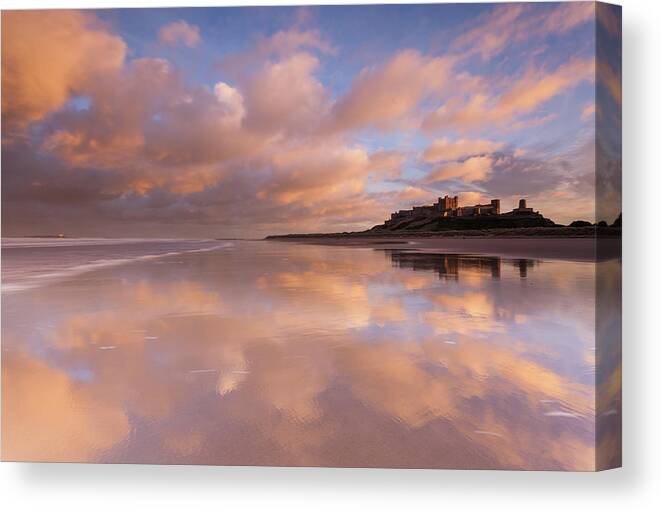 Bamburgh Castle Canvas Print featuring the photograph Bamburgh Castle sunset reflections on the beach by Anita Nicholson