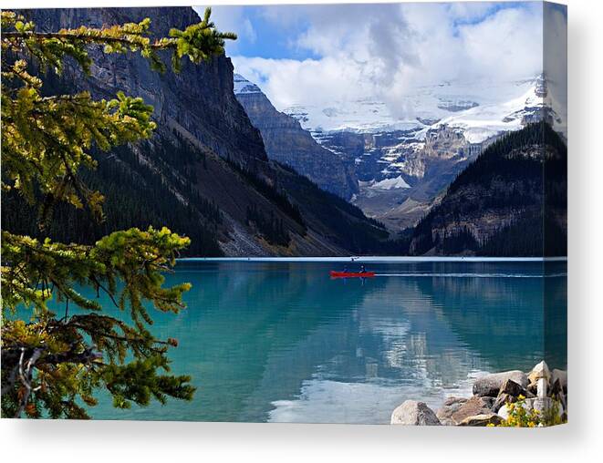 Lake Louise Canvas Print featuring the photograph Canoe on Lake Louise by Larry Ricker