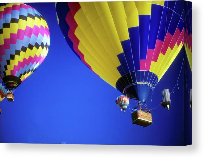 Hot Canvas Print featuring the photograph Hot air balloons against blue sky #1 by Steve Estvanik