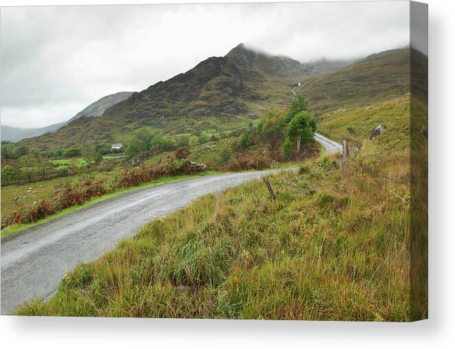 Curve Canvas Print featuring the photograph A Winding Road Over A Hilly Landscape by John Kroetch / Design Pics