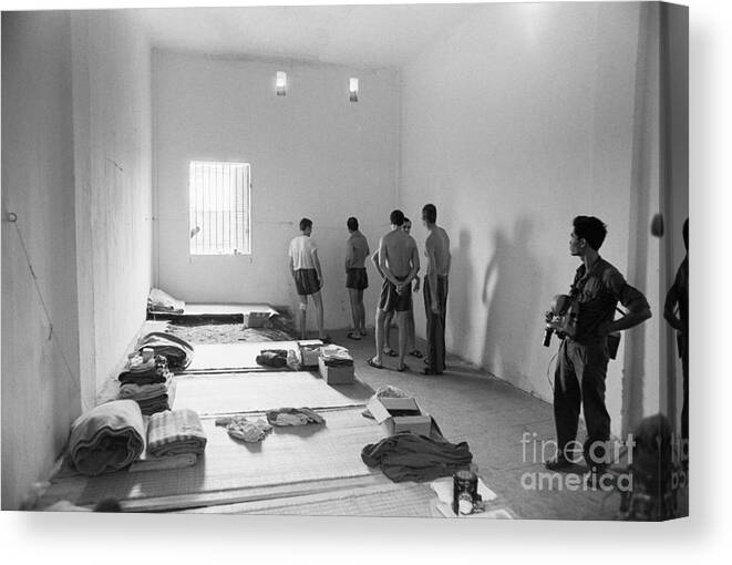 Vietnam War Canvas Print featuring the photograph American Pows In Prison Cell In Hanoi by Bettmann