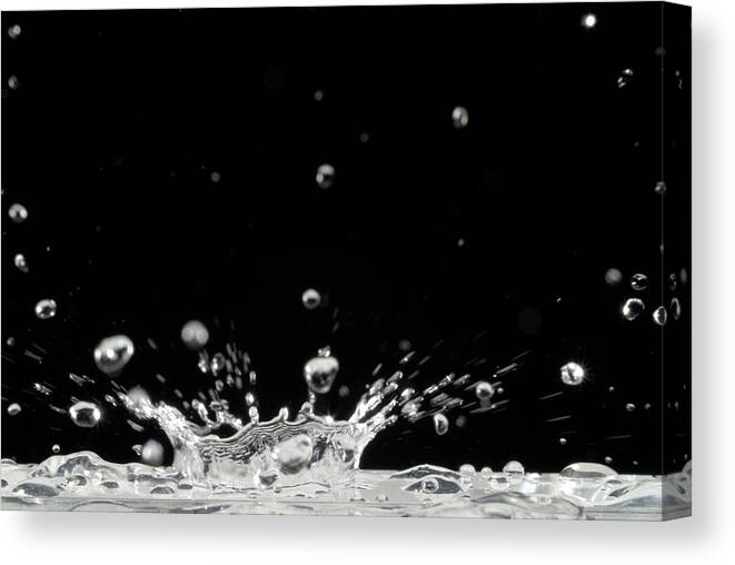 Black Background Canvas Print featuring the photograph Drop Of Water Splashing, Close Up by Sami Sarkis