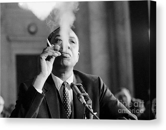 Smoking Canvas Print featuring the photograph Floyd Mckissick Blowing Smoke by Bettmann