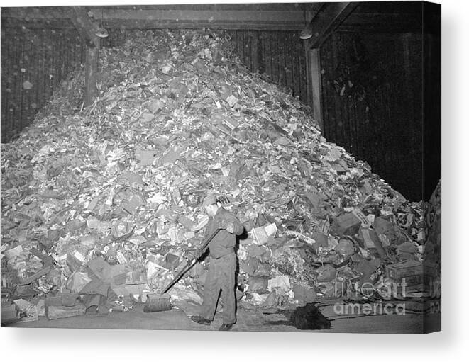 Employment And Labor Canvas Print featuring the photograph Garbage Collector Sweeping Huge Pile by Bettmann