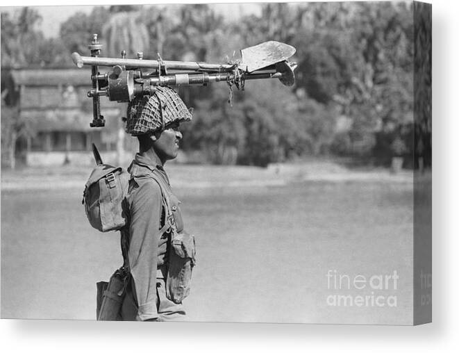 East Canvas Print featuring the photograph Indian Soldier Walks, Gear On Head by Bettmann