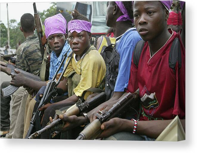Child Canvas Print featuring the photograph Liberian Government Troops Push Back by Chris Hondros
