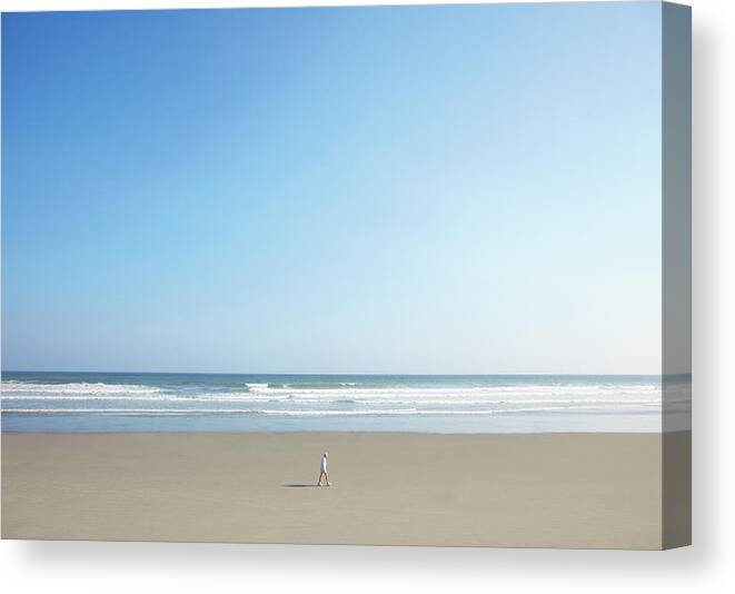 People Canvas Print featuring the photograph Man Walking On Beach by Thomas Northcut