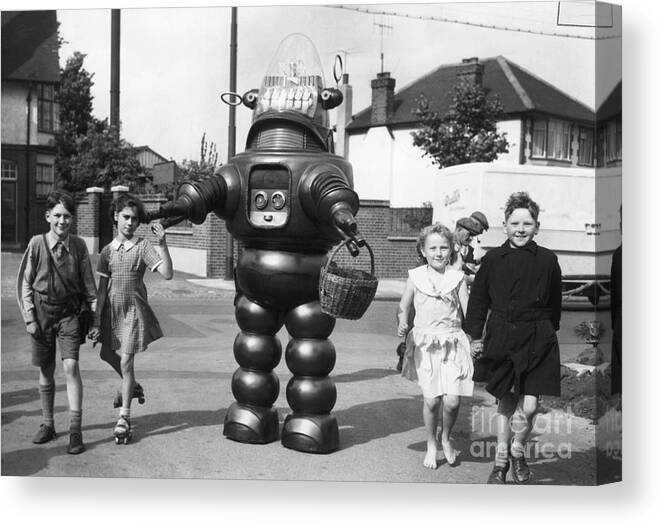 Child Canvas Print featuring the photograph Robby The Robot Walks With Children by Bettmann