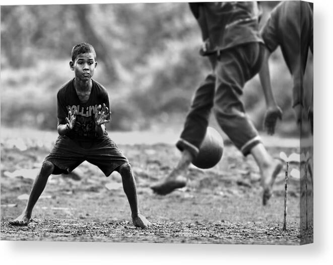 Boy.kid.ball.soccer.beach.sand.field.kick.goal.gam Canvas Print featuring the photograph Serious Threat by Sebastian Kisworo