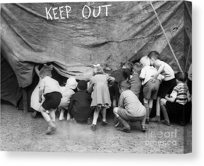 Child Canvas Print featuring the photograph Small Children Sneak Into Circus Tent by Bettmann