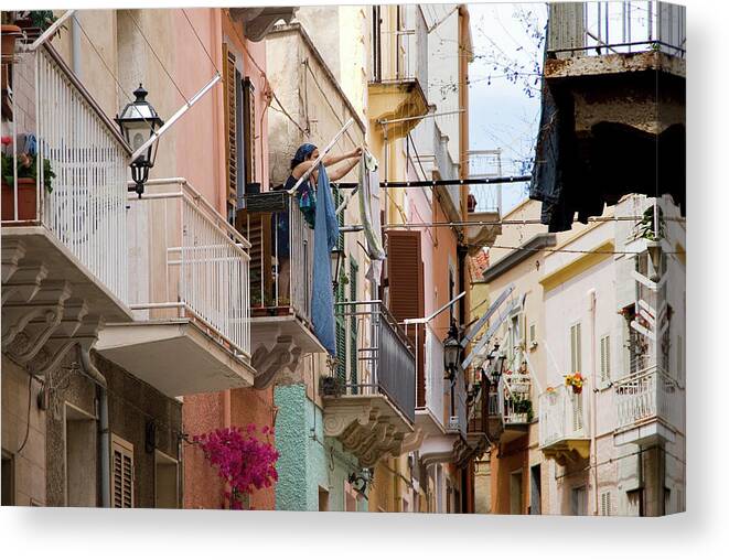 Tranquility Canvas Print featuring the photograph Woman Stretches Out The Clothes To Dry by Aldo Pavan