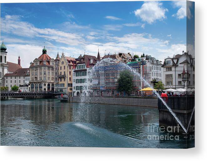 The Kapellbrücke Canvas Print featuring the photograph Reuss River fountain in Old town Lucerne Switzerland #1 by Dejan Jovanovic