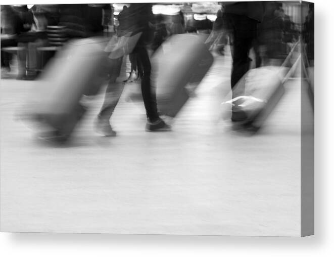 Crowd Of People Canvas Print featuring the photograph Blurred movement of Travellers with luggage by Lyn Holly Coorg