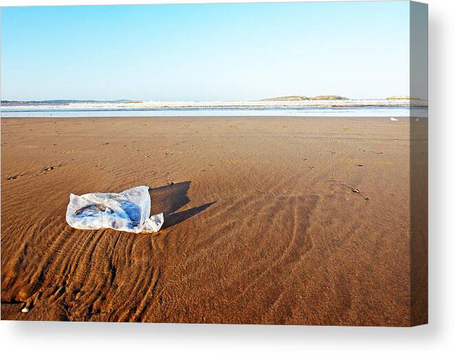 Problems Canvas Print featuring the photograph Plastic bag on beach by Rosmarie Wirz